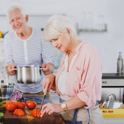 Zwei Personen, die in der Küche kochen und die Spültechnik ist im Hintergrund zu sehen
